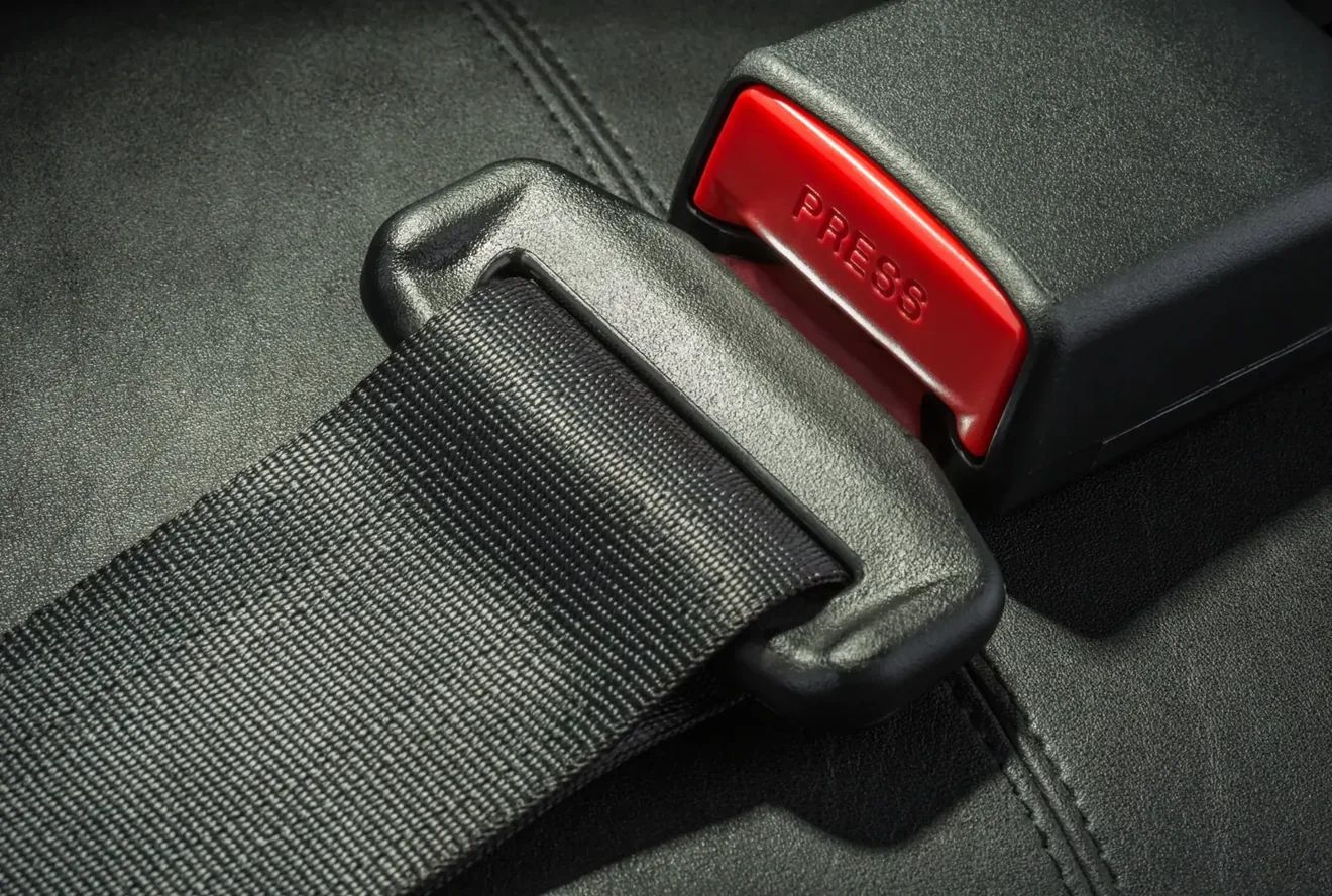 Seat belt assembly showing webbing, latch plate and buckle housing in close detail