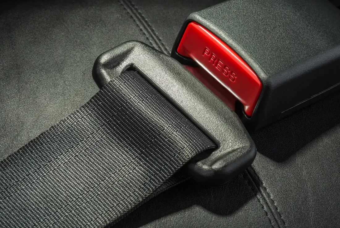 Seat belt assembly detail showing webbing, latch plate and buckle housing