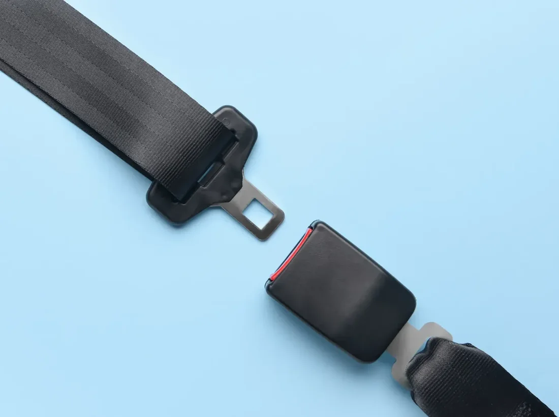 Seat belt assembly with latch plate and buckle shown in close detail